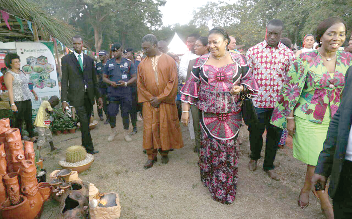 Mrs Rebecca Akufo-Addo (3rd right), being conducted round the exhibition of flowers by Ms Esther Cobbah, (right). Also with them is Prof. Kwabena Frimpong Boateng